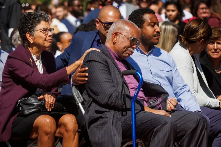 L. Harrison Jay, husband of late JoAnne A. Epps, is consoled during memorial service for his wife.