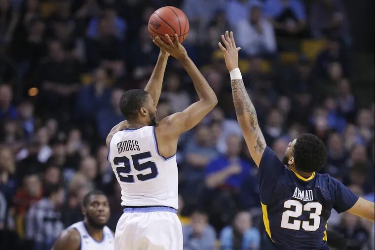 Mikal Bridges of Villanova shoots a 3-pointer against Esa Ahmad of West Virginia during the 2nd half of the East Regionals of the NCAA Tournament at TD Garden on March 23, 2018.
