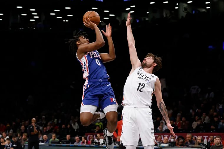 Tyrese Maxey (0) shoots as the Nets' Joe Harris defends during the first quarter. He finished with 12 points.