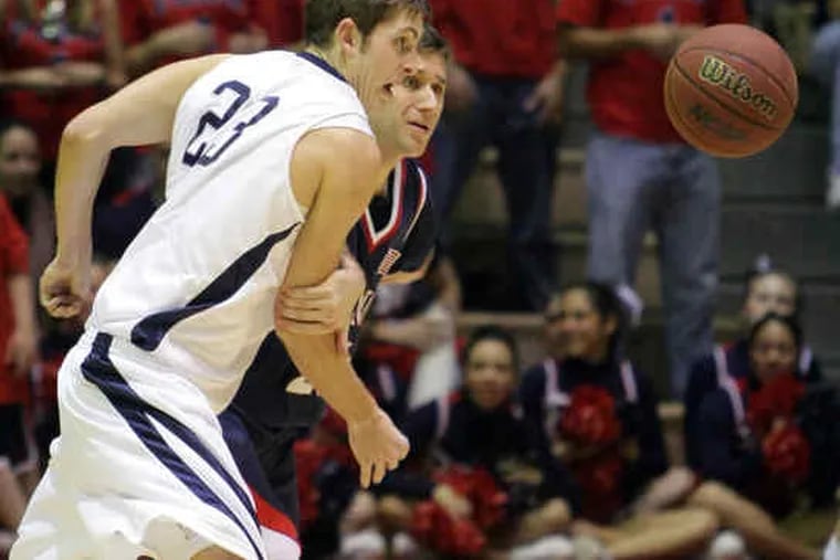 On the court and in the ledger books, Penn came out ahead of Yale. Here, Penn's Brian Grandieri holds back Yale's Nick Holmes during a game in February 2008 thatthe Quakers won.