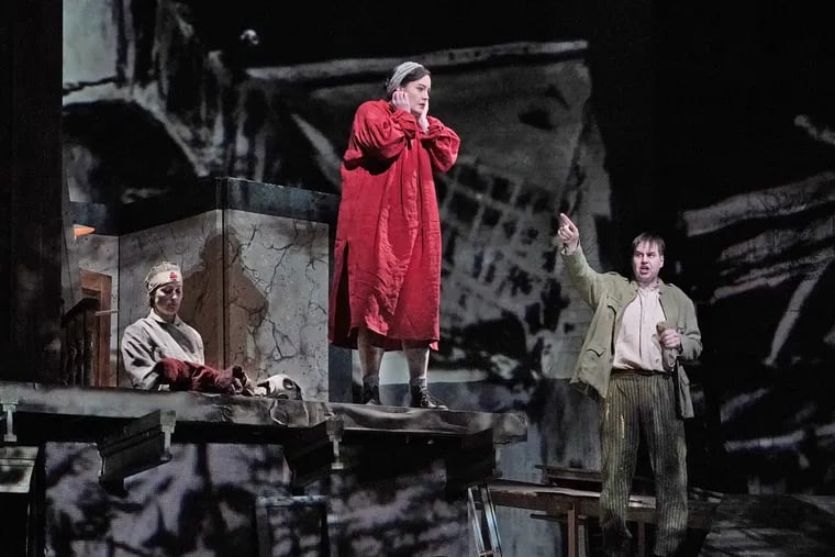 Elza van den Heever (in red) as Marie and Peter Mattei (far right) in the title role of William Kentridge's new production of Berg's "Wozzeck."