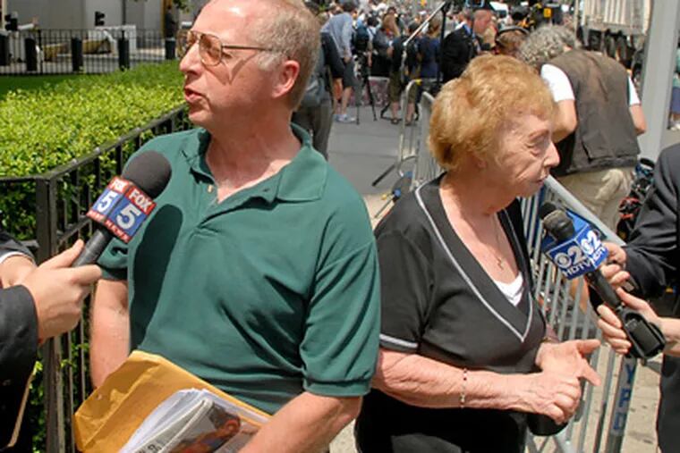 Emma DeVita (right) and her son, Michael T. DeVita, speak to the media outside the courthouse after attending Bernard Madoff’s sentencing. (Tom Gralish / Staff Photographer)