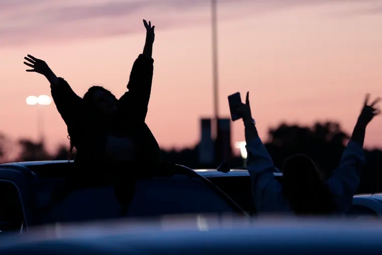 Jessica Pine of Dover, Delaware (left) and Amanda Shores of Wilmington dance in the parking lot to music from the Taylor Swift concert at Lincoln Financial Field in Phila., Pa. on May 13, 2023. 
 
