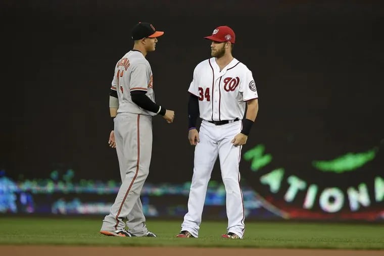 Manny Machado, left, and Bryce Harper are still unsigned even though spring training is only two weeks away from starting.