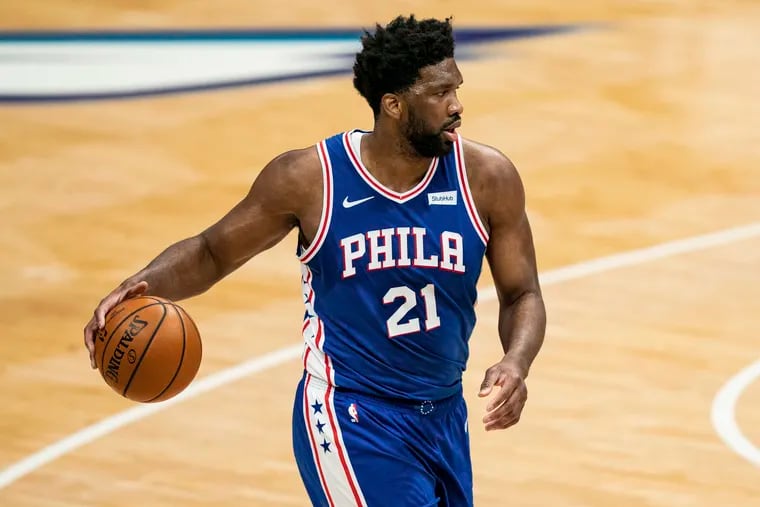 Joel Embiid brings the ball up the court against the Charlotte Hornets.