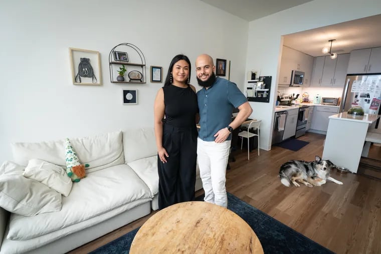 Meredith and Marcos Maciel in the living room of their apartment with Pete the dog in The Carson, in Northern Liberties, in Philadelphia, Monday, March 4, 2024.