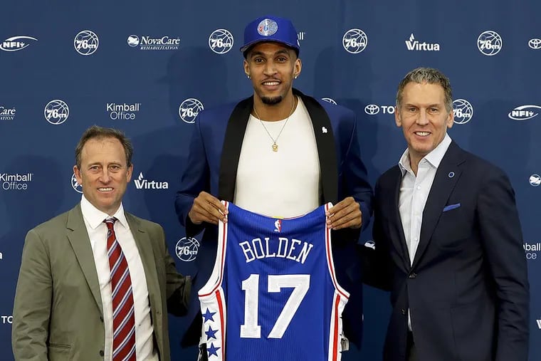 Philadelphia 76ers' draft pick Jonah Bolden, center, poses with team president Bryan Colangelo, right, and managing owner Josh Harris after a news conference at the team's NBA basketball training complex, Friday, June 23, 2017, in Camden, NJ.