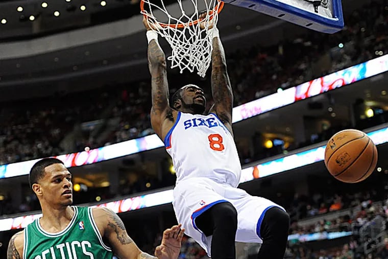 The 76ers' Tony Wroten scores on a dunk over the Celtics' Chris Babb during the first half. (Michael Perez/AP)