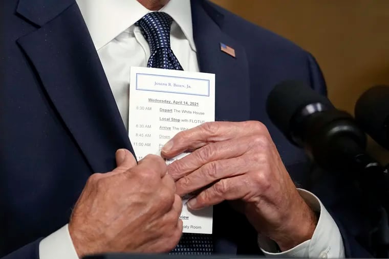 President Joe Biden puts a card into his pocket as he speaks from the Treaty Room in the White House about the withdrawal of the remainder of U.S. troops from Afghanistan.