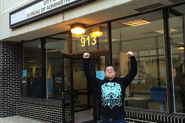 Brian Yan strikes a Rocky pose outside the Bureau of Administrative Adjudication after beating a bad ticket.