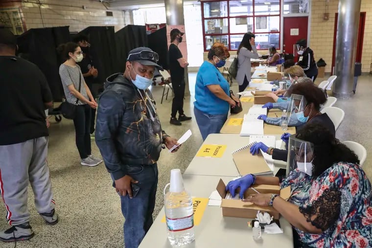 Voters sign in at the Marian Anderson Recreation Center on Election Day in Philadelphia on Tuesday, June 02, 2020. There were fewer polling locations across the city for people to vote from on Pennsylvania's primary election day due to the coronavirus pandemic.