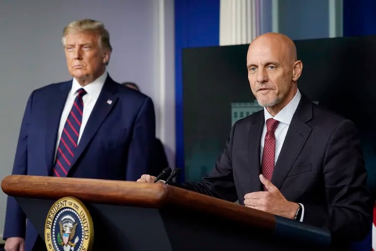 President Donald Trump (left) listens as Dr. Stephen Hahn, commissioner of the U.S. Food and Drug Administration, speaks during a media briefing at the White House on Sunday.