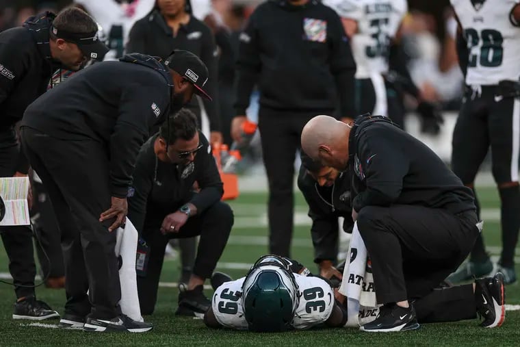 Injured Eagles cornerback Eli Ricks is checked on during the loss to the Jets at MetLife Stadium.