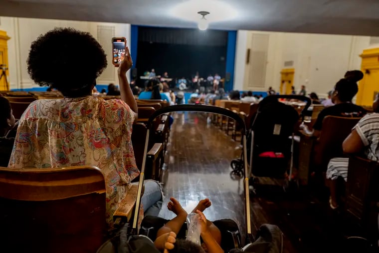 August 21, 2023: Quashima Hill records video as some of her children participate in an end-of-the-summer performance during the Germantown Summer Showcase at Roosevelt Elementary School.