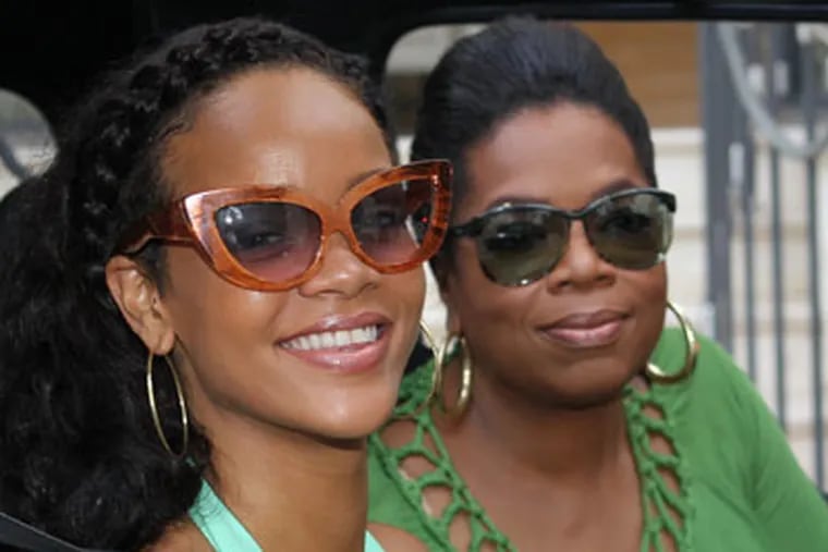 This Aug. 4, 2012 image released by Harpo Productions shows singer Rihanna, left, with Oprah Winfrey during an interview for "Oprahís Next Chapter" in Barbados.  The interview, in which Rihanna speaks about her relationship with Chris Brown, will air on Sunday, Aug. 19 at 9p.m. EST on OWN. (AP Photo/Harpo Productions, George Burns)