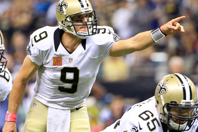 New Orleans Saints quarterback Drew Brees (9) gestures from the field against the Dallas Cowboys during the first quarter at the Mercedes-Benz Superdome.
