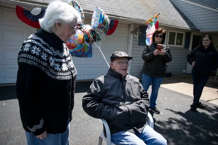 Eleanor Castro stands with her husband, Sal Castro, after a drive-by parade for his 95th birthday celebration in Levittown, Pa., on Sunday, May 10, 2020. The Guardians of the National Cemetery, of which Castro is a member, put on the celebration.