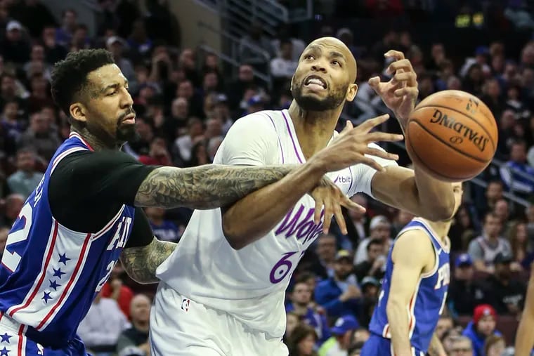 The Sixers' Wilson Chandler fouls the Timberwolves' Taj Gibson (right) during the third quarter.