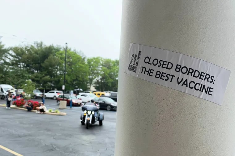 A sticker advertising the New Jersey European Heritage Association, a white-supremacist group, is on a pole outside the Atilis Gym in Bellmawr, N.J., which reopened despite government-ordered shutdowns.