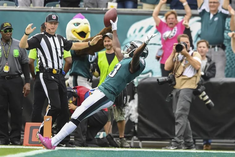 Eagles wide receiver Nelson Agholor falls into the end zone backwards with a 72-yard TD reception against the Arizona Cardinals on Sunday.