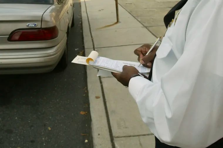 9/27/04 – Philadelphia, PA – Philadelphia Parking Authority Supervisor James Butler monitors and tickets cars parked illegally outside the Emlen Elementary School at Chew and Upsal St on Monday, September 27, 2004.
