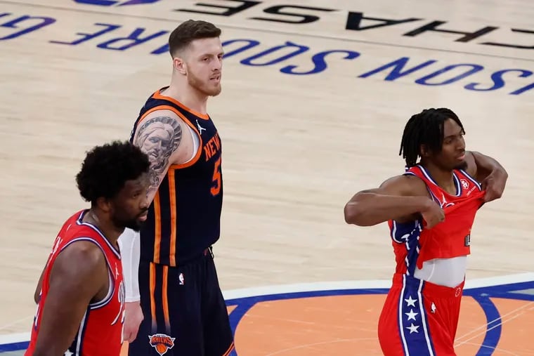 Center Joel Embiid (left) and guard Tyrese Maxey react after the Sixers lost to the New York Knicks in Game 2 of their playoff series on Monday. New York's Isaiah Hartenstein is in the middle.