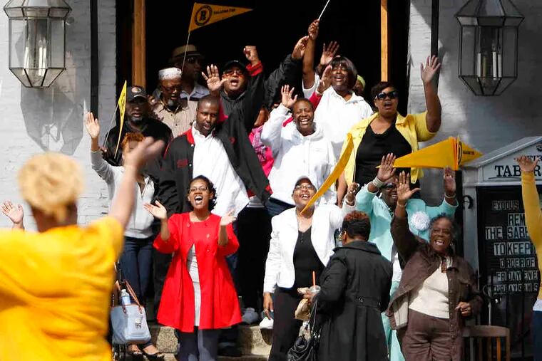 Members of the First Tabernacle Church of God choir cheering the thousands of runners on in the 10-mile Broad Street Run on Sunday near South Street.