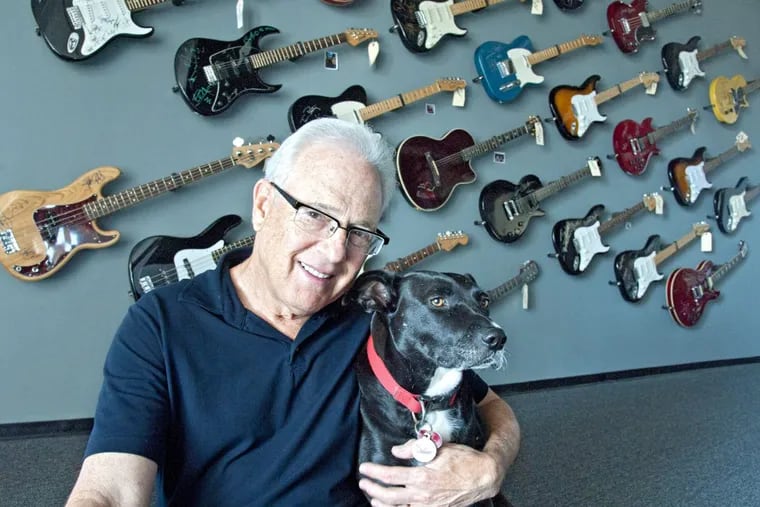 Larry Magid, cofounder of Electric Factory Concerts, with his dog Midnight in the lobby of his company's offices at the Piazza at Schmidt's.