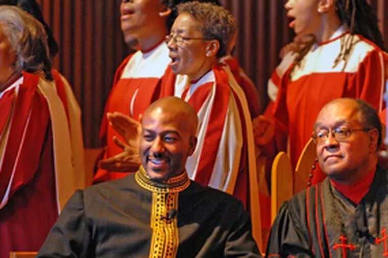 Rev. Kevin Johnson (center), shown in February with Rev. William H. Gray III, plans a Jericho-like march to prevent the gentrification of a now-closed school.