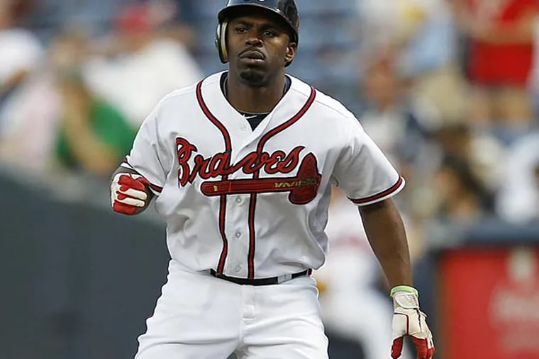 Atlanta Braves center fielder Michael Bourn (24) takes a lead from first during a baseball game against the Colorado Rockies Wednesday, Sept. 5, 2012, in Atlanta,. (AP Photo/John Bazemore)