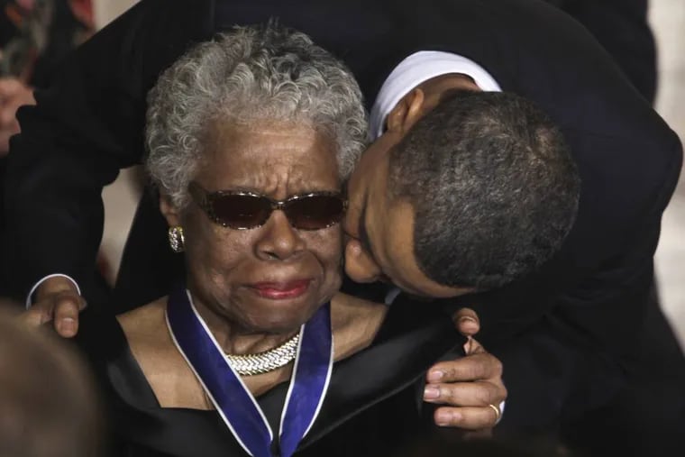 FILE - In this Feb. 15, 2011 file photo, President Barack Obama kisses author and poet Maya Angelou after awarding her the 2010 Medal of Freedom during a ceremony in the East Room of the White House in Washington. Angelou, author of "I Know Why the Caged Bird Sings," has died, Wake Forest University said Wednesday, May 28, 2014.  She was 86. (AP Photo/Charles Dharapak, File)