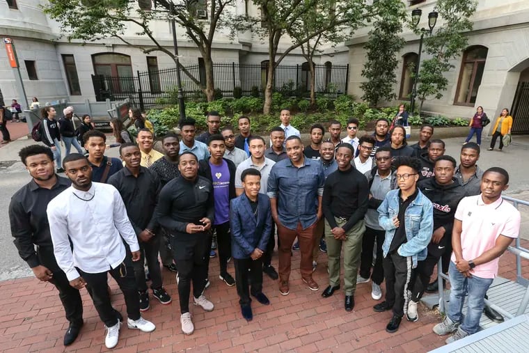 The Achievers Brunch, started by Mister Mann Frisby (center), helps teach male college-bound students how to cope on campus.