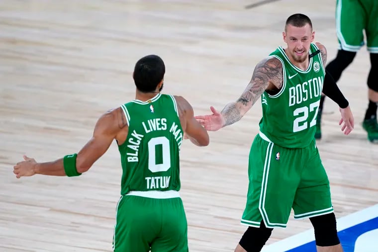The Boston Celtics' Jayson Tatum with Daniel Theis during a game against Toronto on Aug. 7.