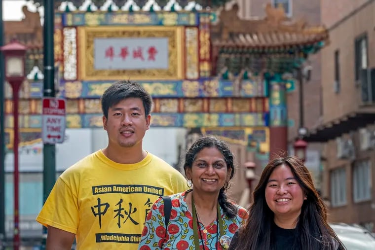 Officers with Asian Americans United stand for a portrait at the Chinatown Gate, ahead of the Mid-Autumn Festival on Saturday, Sept. 17. From left are Wei Chen, civic engagement director; Neeta Patel, interim executive director; and Cinthya Hioe, social media coordinator and youth organizer. The Mid-Autumn Festival returns to Chinatown this year, a live resumption of the big holiday celebration after two years of online events. The 27th annual festival starts at noon, featuring musical performances, carnival games, and the ever-popular mooncake-eating contest.