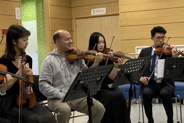 Philadelphia Orchestra associate principal violinist Paul Roby coaches members of ShanghaiTech student orchestra.