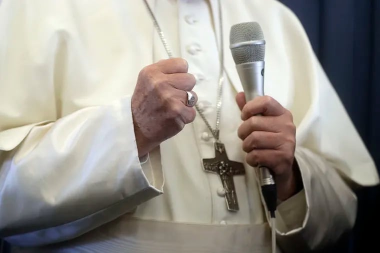 Pope Francis gestures as he answers to a journalist's question during a press conference aboard of the flight to Rome at the end of his two-day visit to Ireland, Sunday, Aug. 26, 2018.