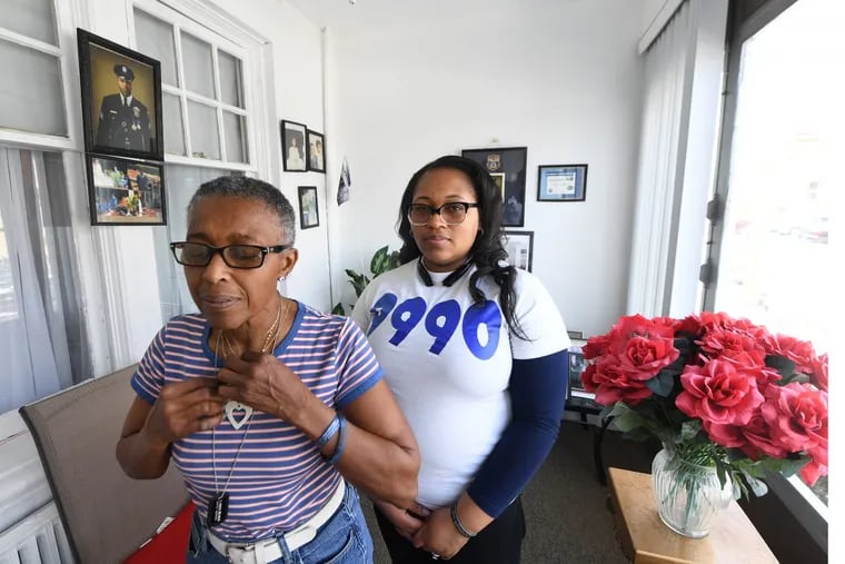 Shaki’ra Wilson-Burroughs, sister of the late Sgt.Robert Wilson, and Constance Wilson, grandmother, front, at their home in Cobbs Creek, Philadelphia. Thursday, March 22, 2018. JOSE F. MORENO / Staff Photographer