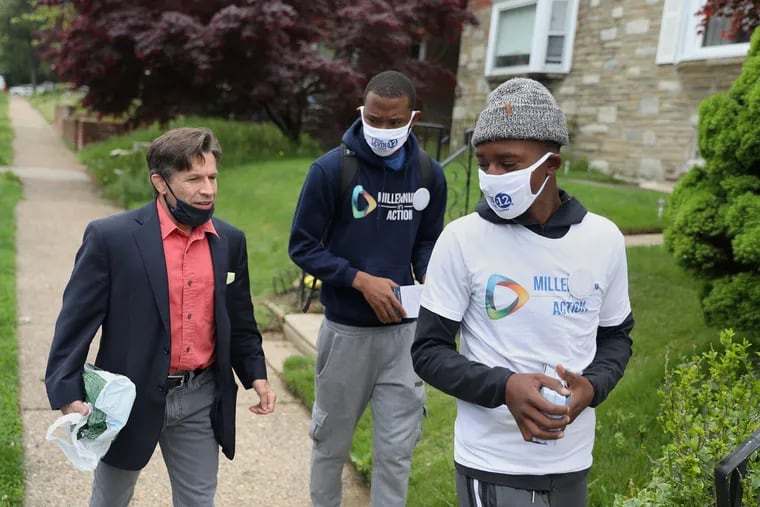 Dante Riley, right, and Keyon Jessup, center, work in North Philadelphia on May 4 to increase voter turnout in the May 18 primary election, including for judicial candidate John Padova Jr., left. Riley and Jessup are part of Millennials in Action, which works to engage young voters in marginalized communities.