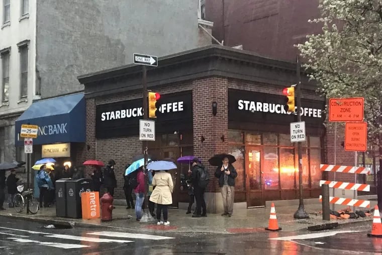 Protesters gather outside Starbucks at 18th and Spruce Streets on Monday.