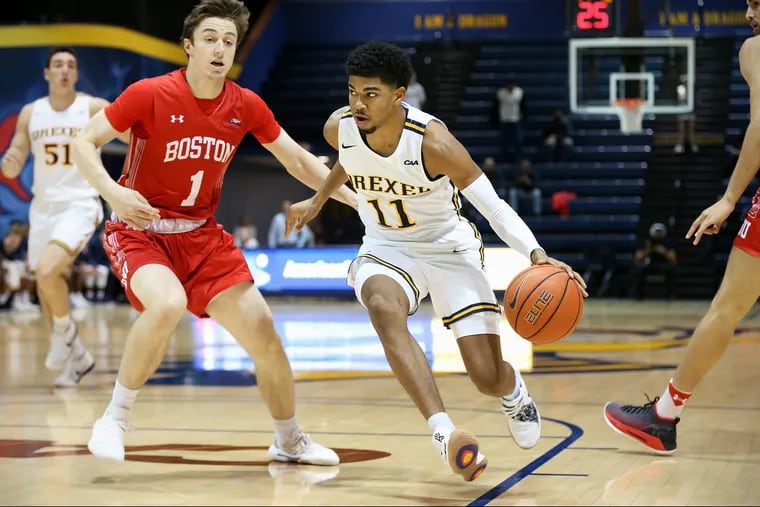 Drexel guard Camren Wynter (11) drives past BU guard Garrett Pascoe (1) during a game at the Daskalakis Athletic Center in Philadelphia's University City section on Wednesday, Nov. 21, 2018. TIM TAI / Staff Photographer