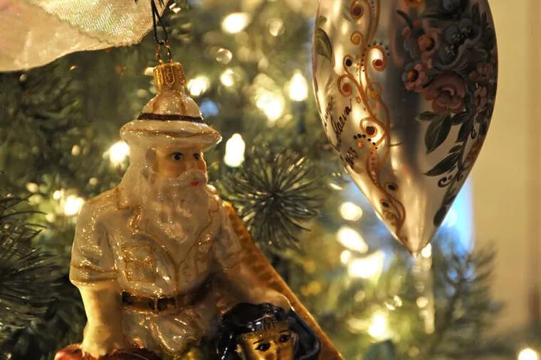 This ornament, of Santa the adventurer with a pyramid and pharaoh, calls to mind a family trip to Egypt. The Giordanos' living-room tree is decorated with treasures representing travel and family history.