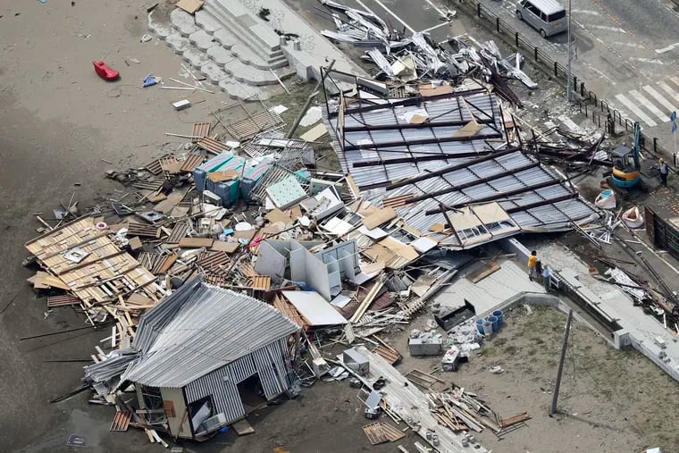Beach houses are damaged as typhoon hits the beacfront area in Miura, south of Tokyo, Monday, Sept. 9, 2019. Typhoon Faxai is blowing across the Tokyo metropolitan area, disrupting travel, knocking out power and causing dozens of injuries.