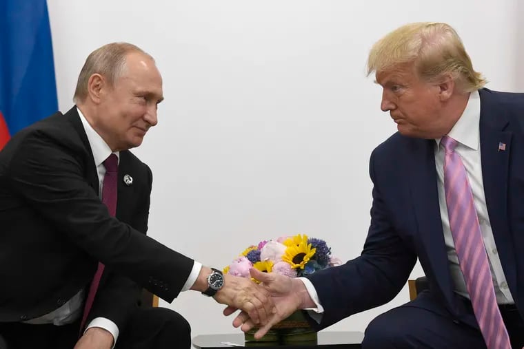 President Donald Trump, right, shakes hands with Russian President Vladimir Putin, left, during a bilateral meeting on the sidelines of the G-20 summit in Osaka, Japan, Friday, June 28, 2019. Trump claimed in a July 2020 interview to have authorized a clandestine military cyberattack against Russia's internet access during the 2018 mid-term elections.