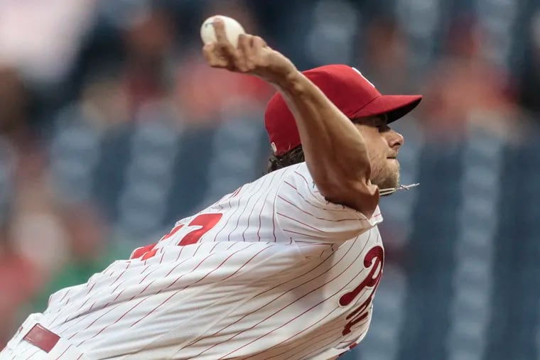 Phillies pitcher Aaron Nola throws against the Braves during the first inning.