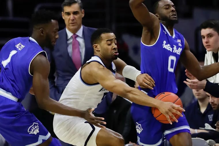 Villanova guard Phil Booth forces a turnover against Seton Hall guard Quincy McKnight (right) and forward Michael Nzei during the first half of their matchup on Sunday.