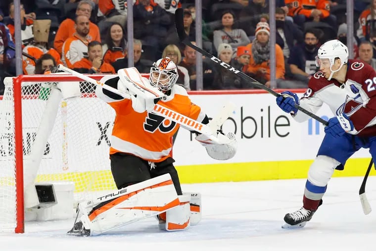 Flyers goaltender Martin Jones stops the puck against Colorado Avalanche center Nathan MacKinnon during the second period.