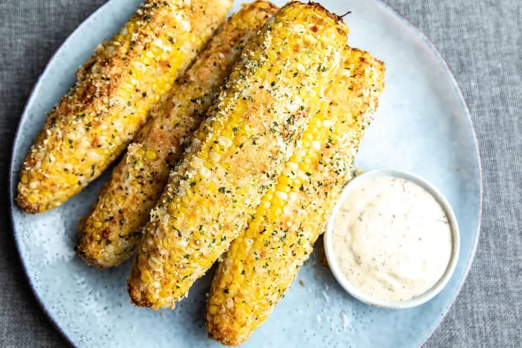 Di Bruno Bros.' grilled corn is brushed with truffle butter and rolled in a crispy breadcrumb, Parmesan, and parsley topping.