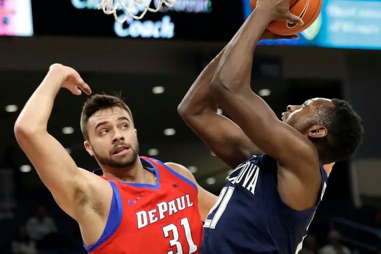 Villanova forward Dhamir Cosby-Roundtree, right, shoots against DePaul guard Max Strus during the first half of an NCAA college basketball game Wednesday, Jan. 30, 2019, in Chicago. (AP Photo/Nam Y. Huh)