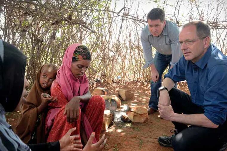 Andrew Witty (right), GlaxoSmithKline CEO, and Justin Forsyth, Save the Children CEO, in Kenya with Aisha, 25, and daughter Leila, 5. (Sven Torfinn / Save the Children)