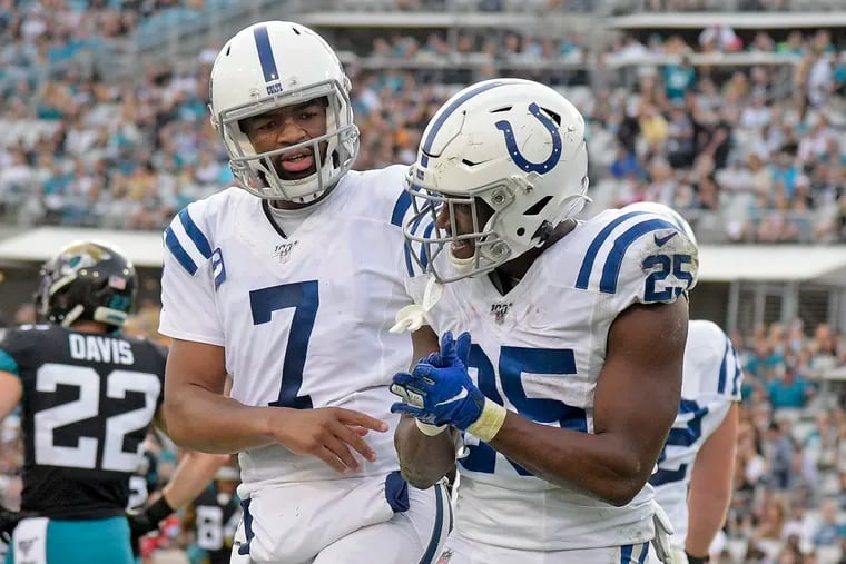 Indianapolis Colts quarterback Jacoby Brissett (7) congratulating running back Marlon Mack for his 5-yard touchdown run against the Jacksonville Jaguars on Dec. 29, 2019. Both players might interest the Eagles in free agency.